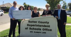 A group of SHP leaders delivering a check.