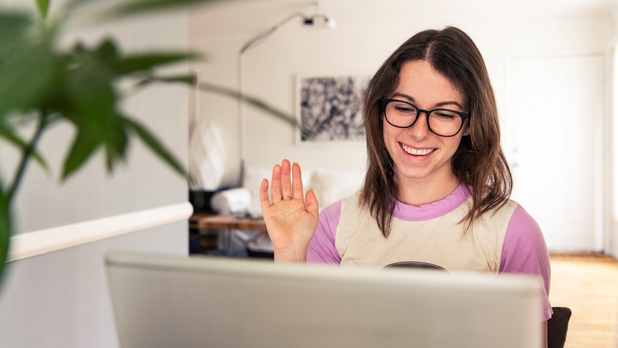 Young women having video chat while working at home.