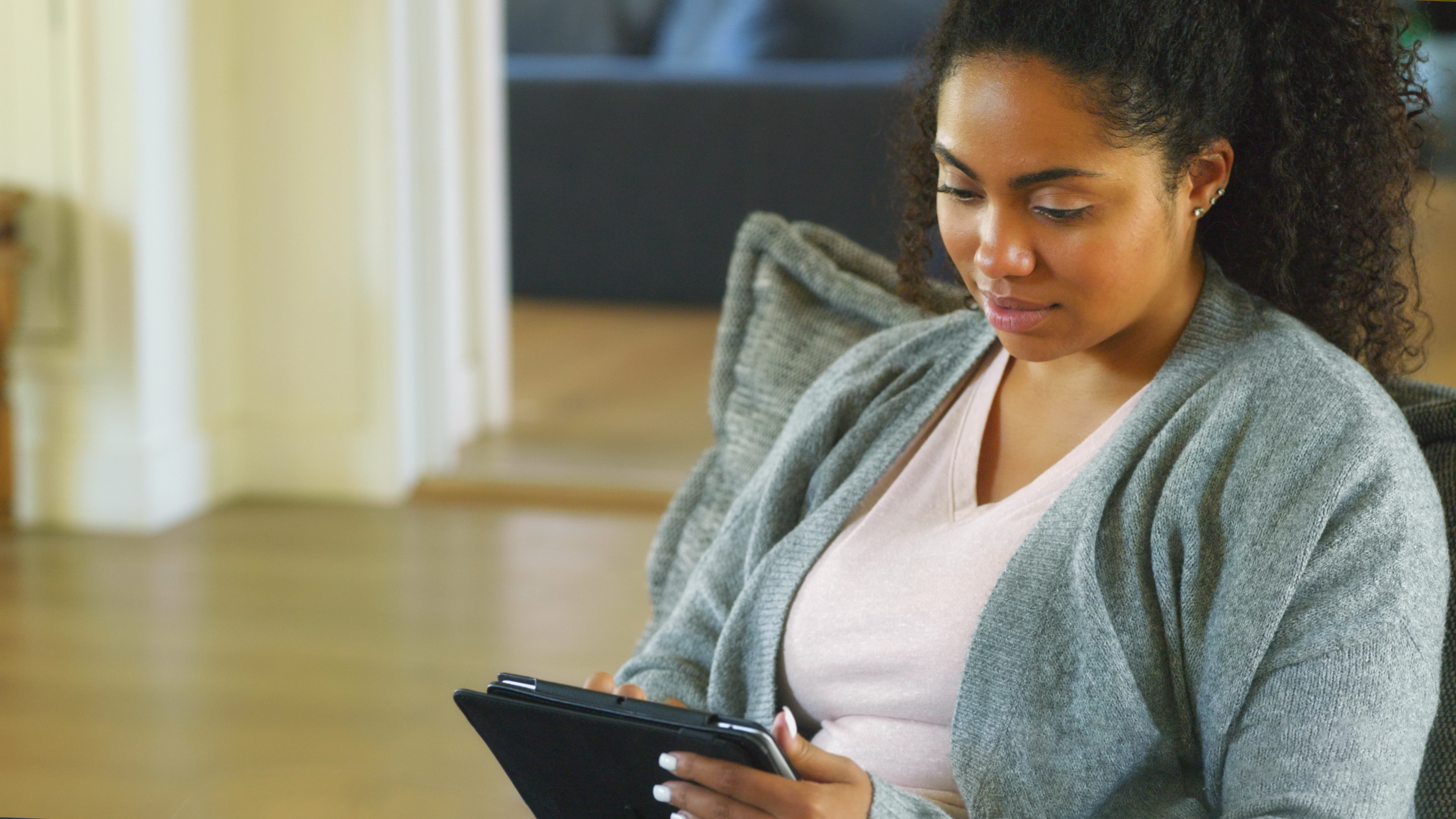 An image of a woman on a tablet.