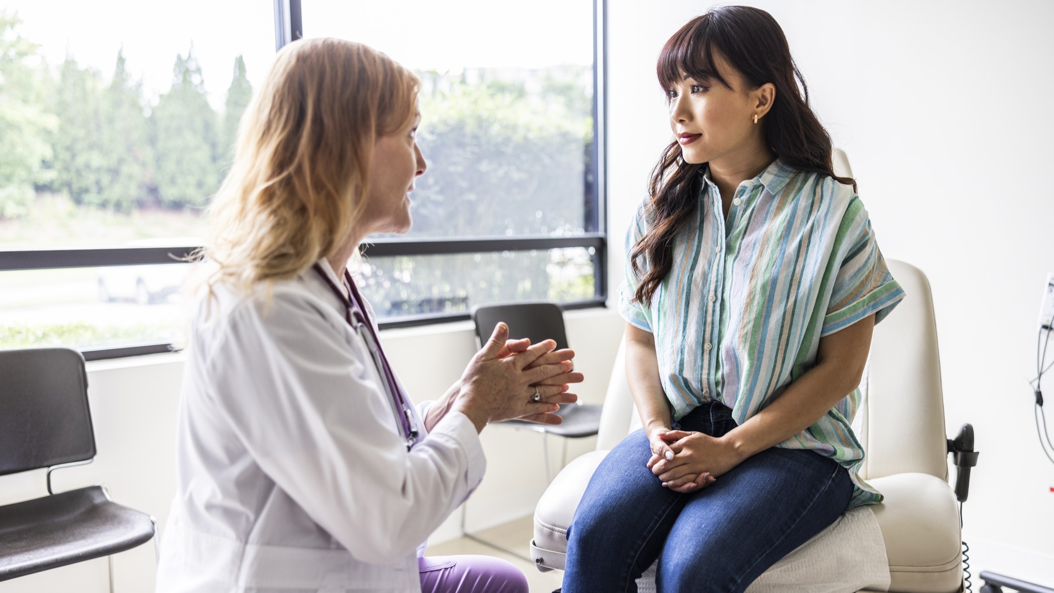 Woman doctor speaking to woman patient