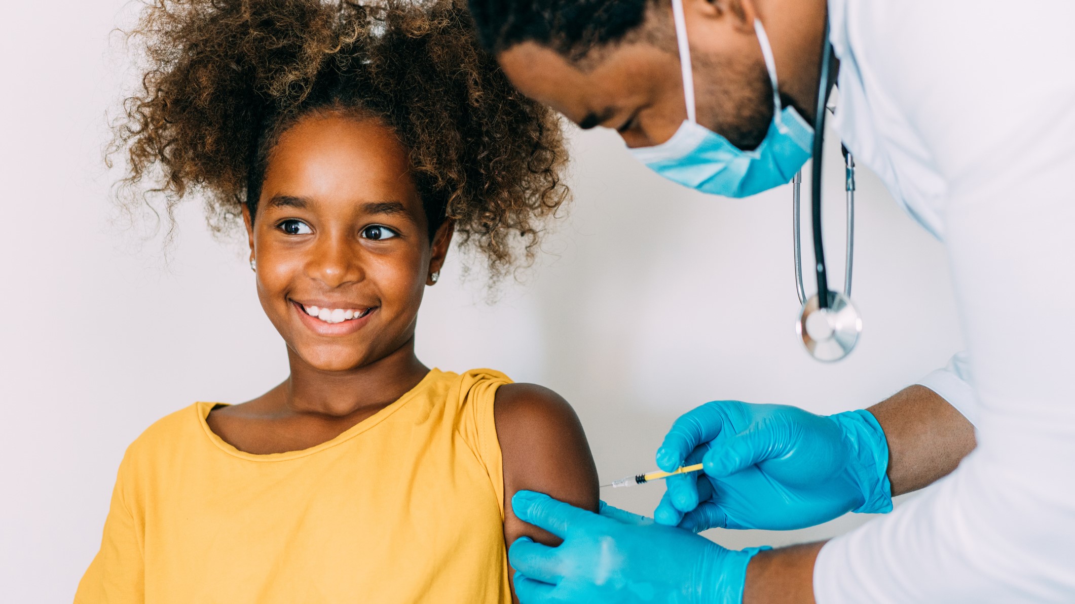 Tween girl receiving a vaccination