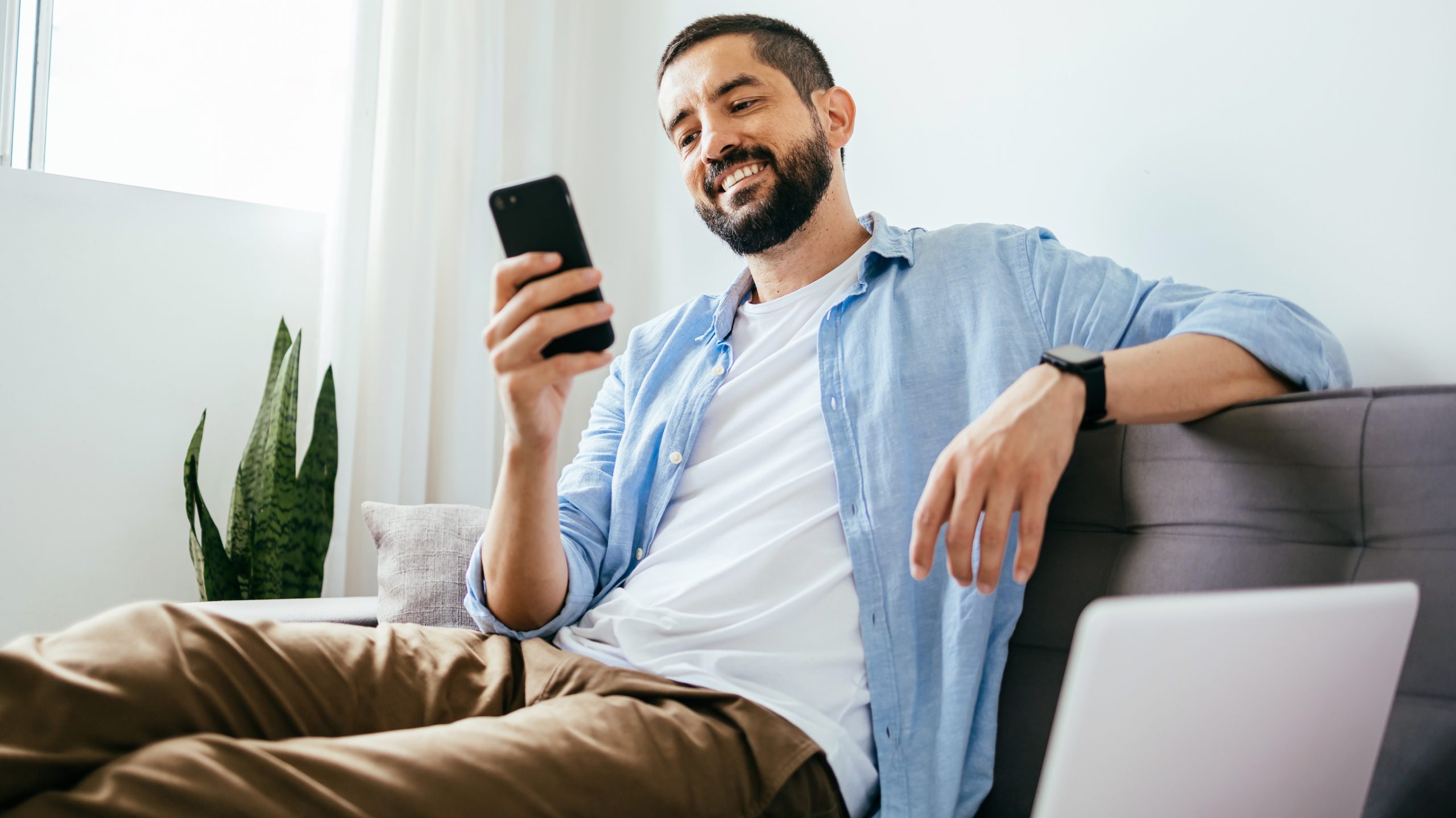 Smiling man using smartphone