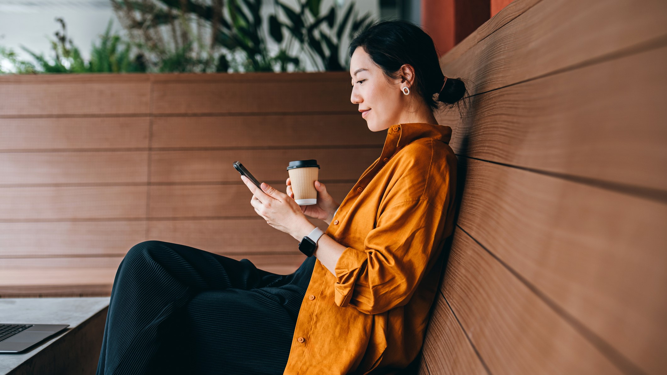 Woman relaxing and looking at her phone