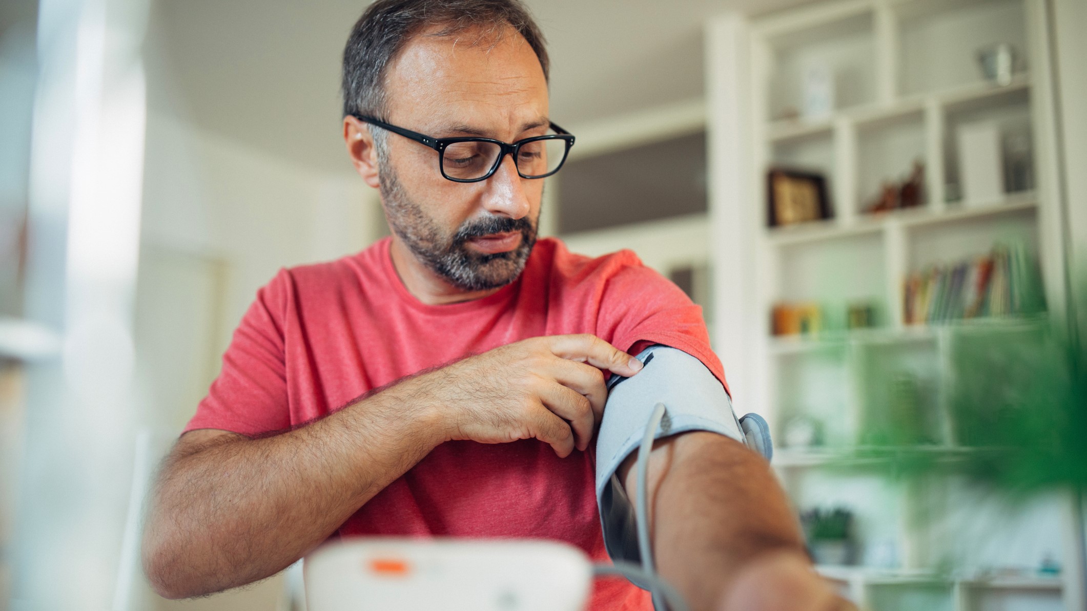 Man taking his blood pressure at home