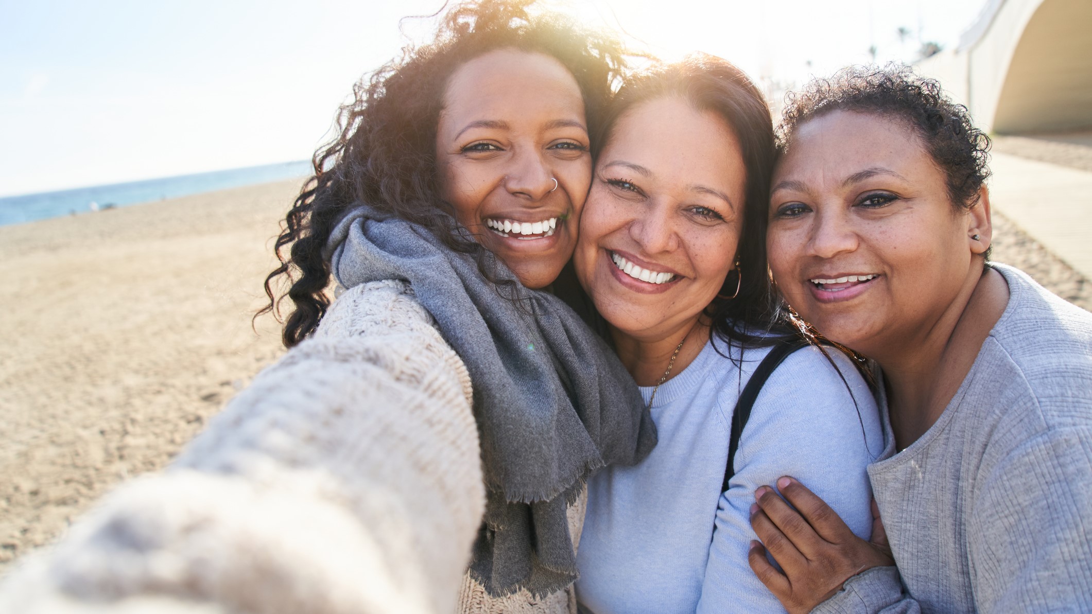 Three healthy women smiling into a camera