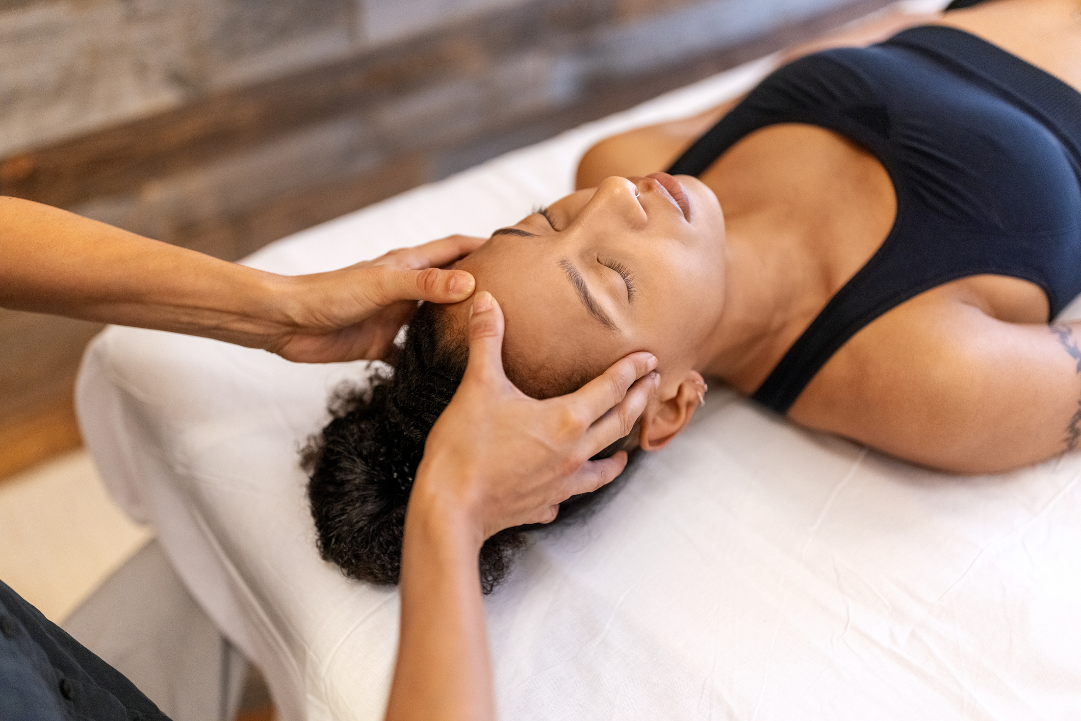 Patient receiving relaxing head massage during a therapy session Patient receiving relaxing head massage during a therapy session